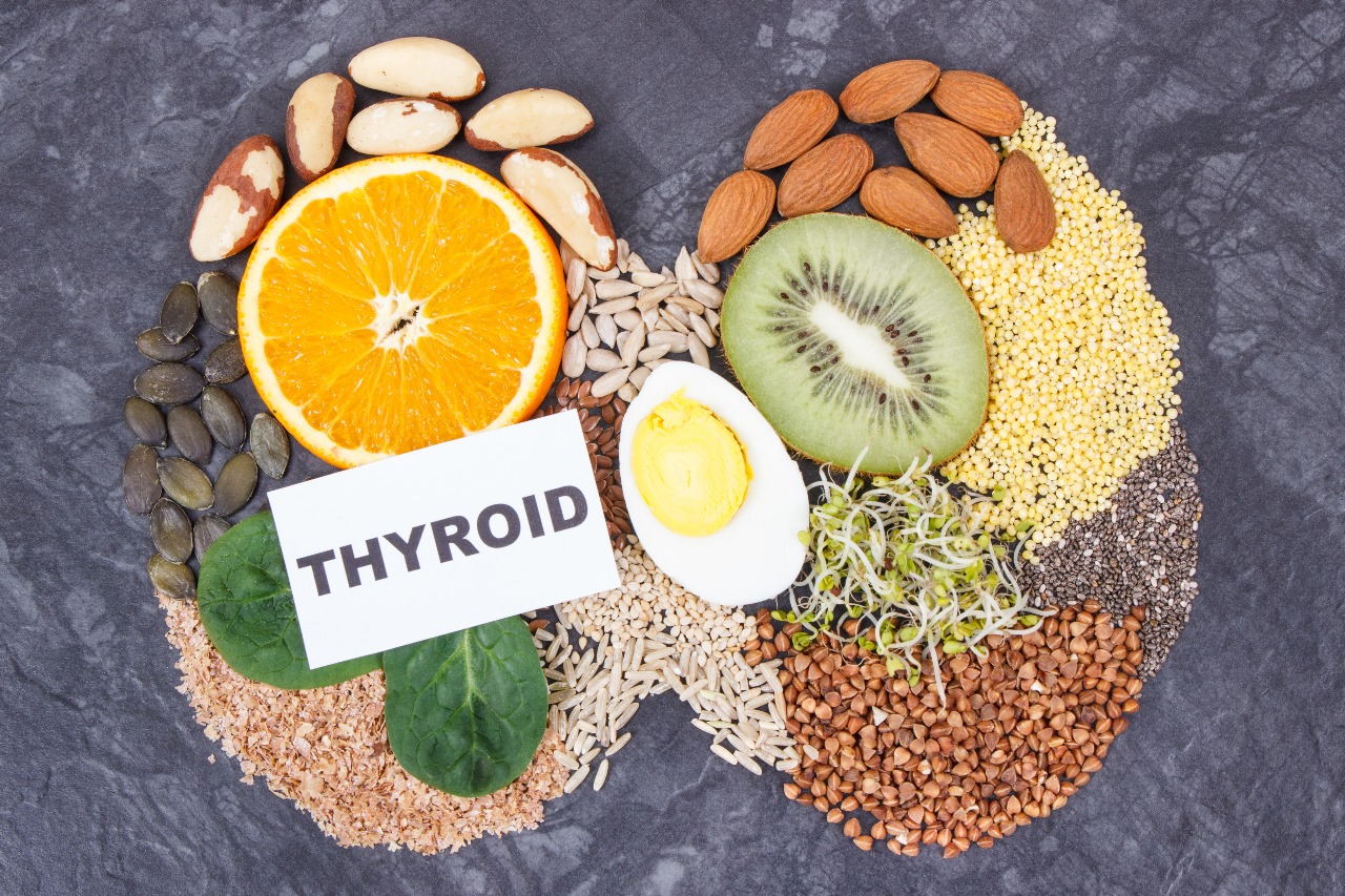 Thyroid-friendly foods including fruits, nuts, seeds, grains, and protein sources